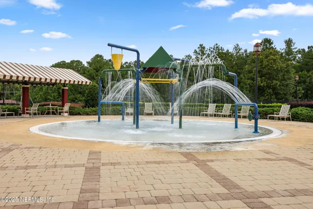 a swimming pool with outdoor seating and yard in back