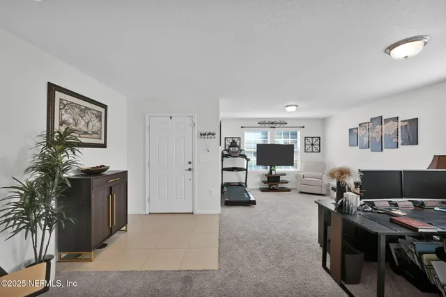a view of a livingroom with workspace and a couch