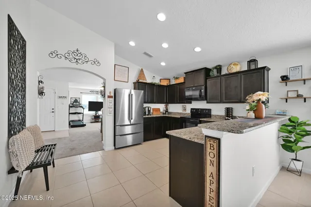 a kitchen with refrigerator and cabinets