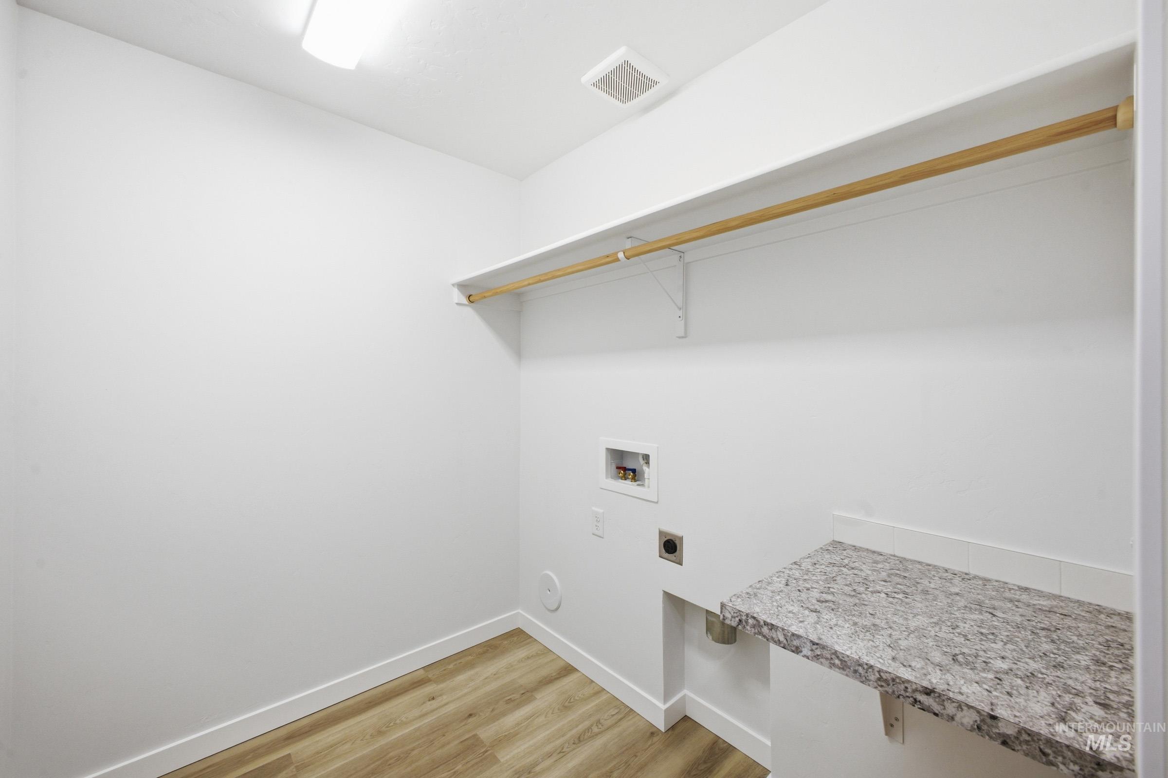 13724 Judson Street Caldwell, ID 83607 - Photo 11 of 23 Laundry area with light wood-type flooring, hookup for a washing machine, and electric dryer hookup