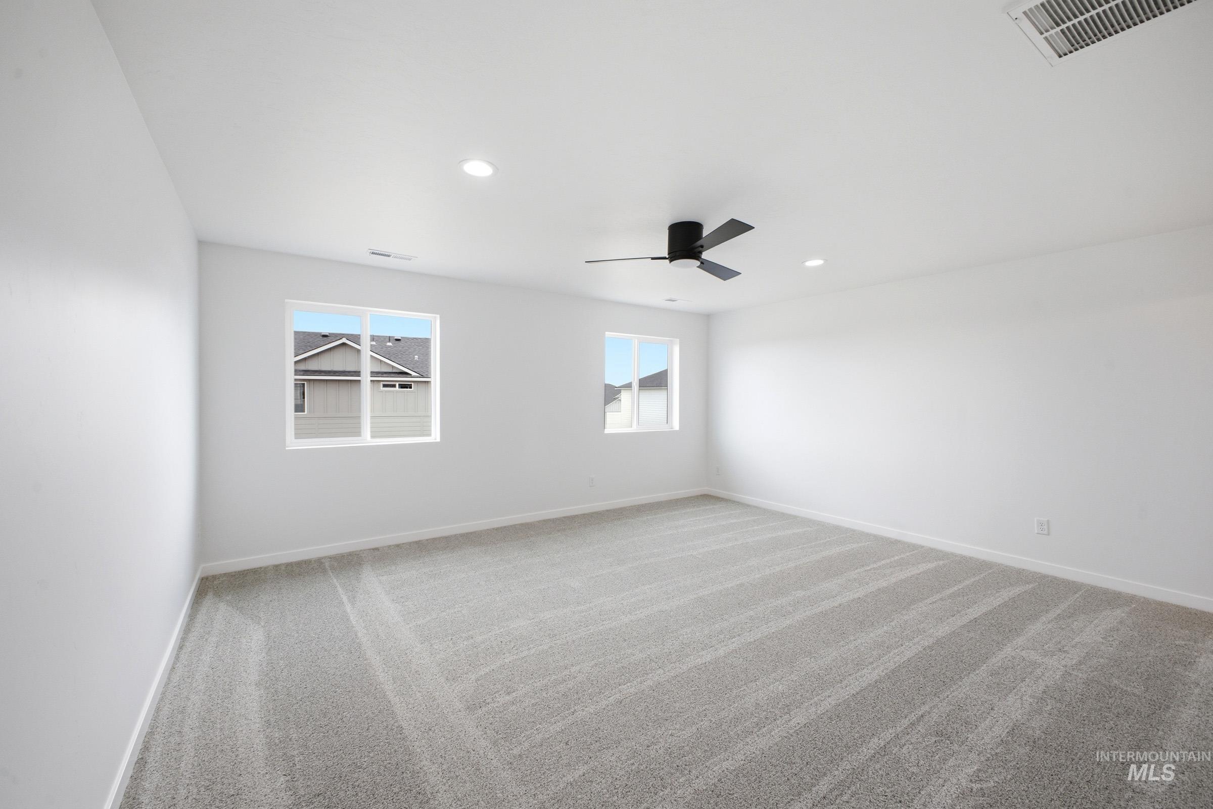 13724 Judson Street Caldwell, ID 83607 - Photo 18 of 23 Empty room featuring light carpet, a ceiling fan, and recessed lighting