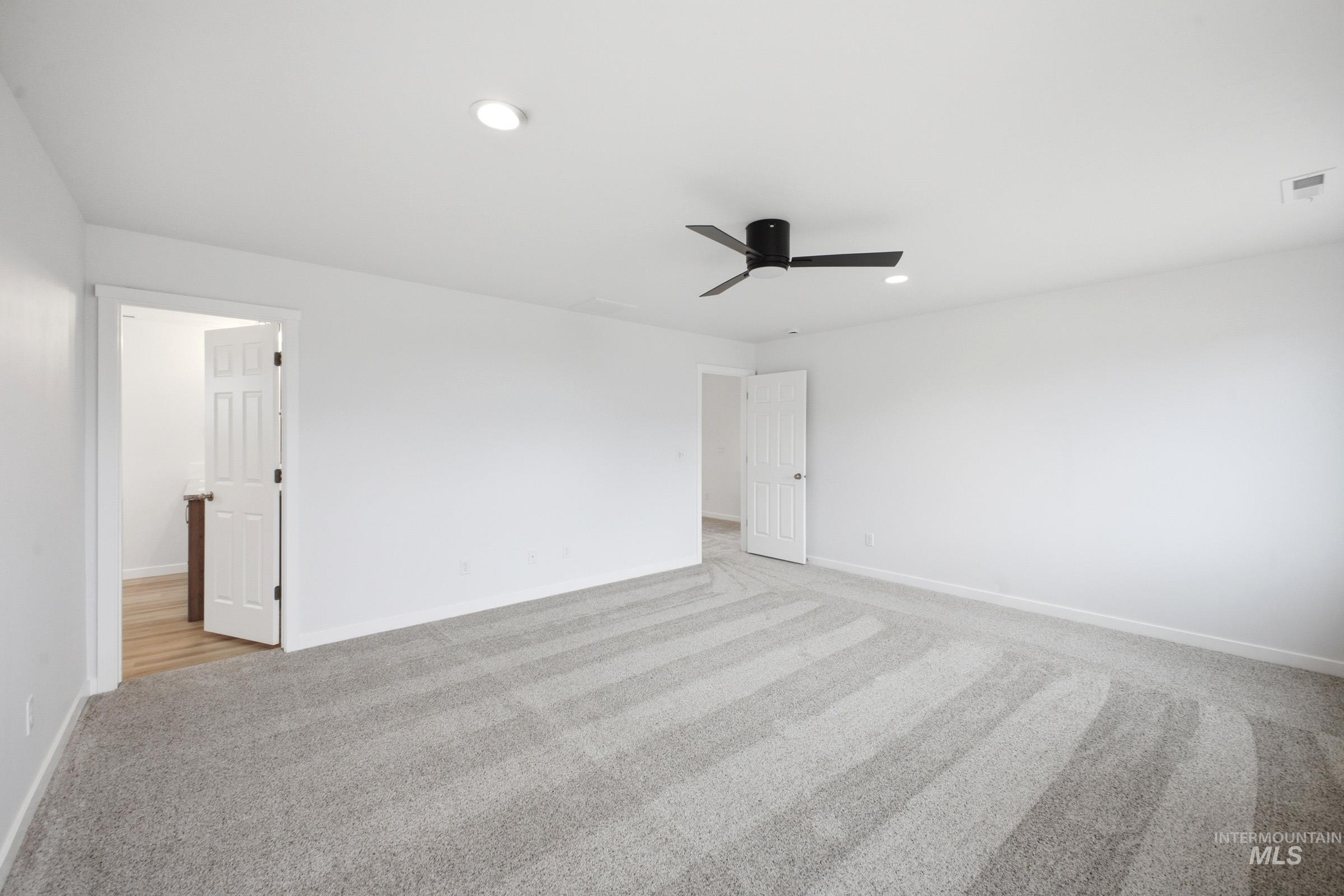 13724 Judson Street Caldwell, ID 83607 - Photo 19 of 23 Unfurnished bedroom with light colored carpet, a ceiling fan, and recessed lighting