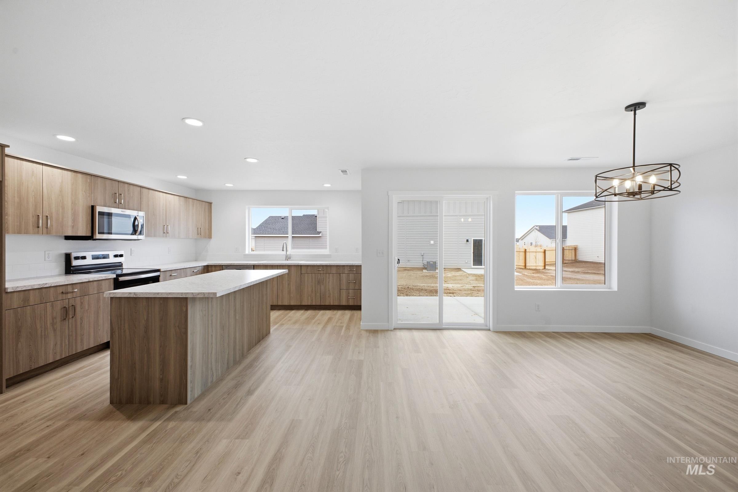 13724 Judson Street Caldwell, ID 83607 - Photo 23 of 23 Kitchen with a kitchen island, light wood-style floors, stainless steel appliances, open floor plan, and modern cabinets