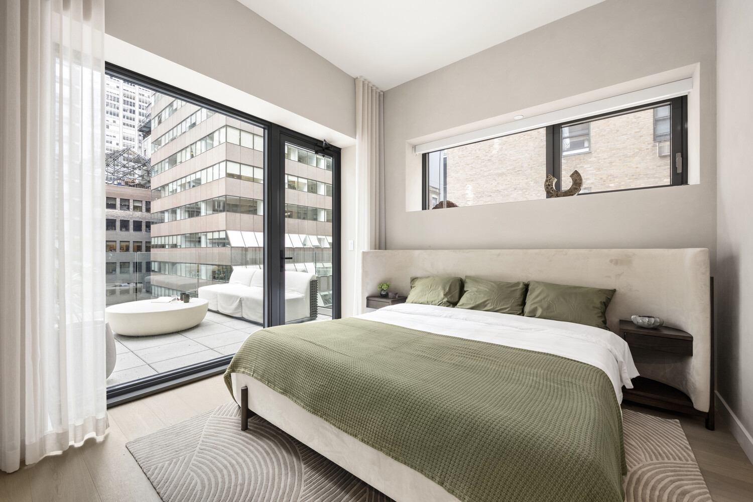 126 East 57th Street, Unit 1805 Manhattan, NY 10022 - Photo 1 of 24 a bedroom with a bed and a large window