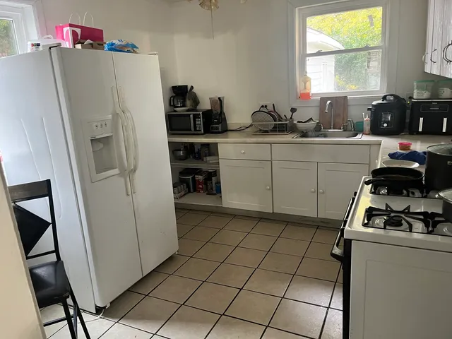 a kitchen with a refrigerator and a sink