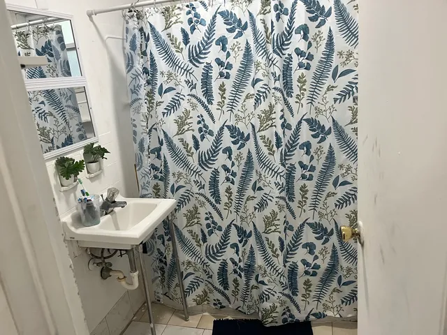 a bathroom with a sink and mirror with toilet