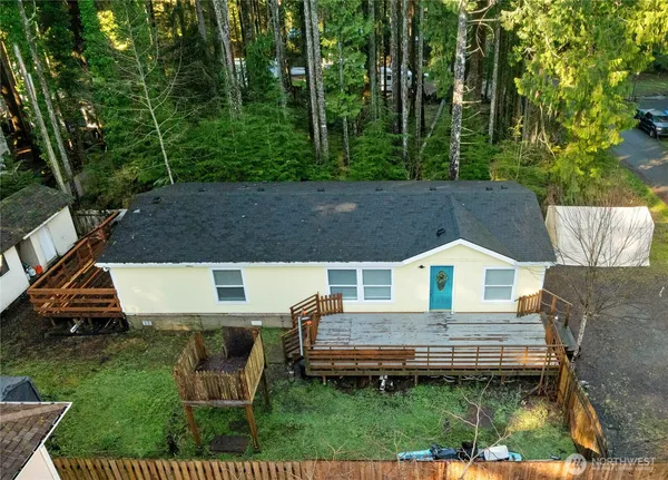 an aerial view of a house with a yard