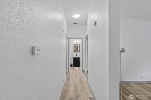 a view of a hallway with wooden shelves