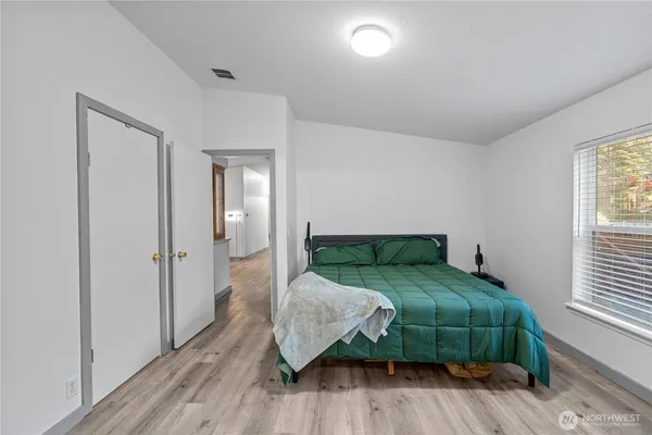 a bedroom with a bed and a mirror