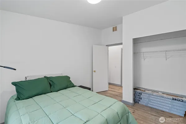 a bedroom with a bed and a night stand