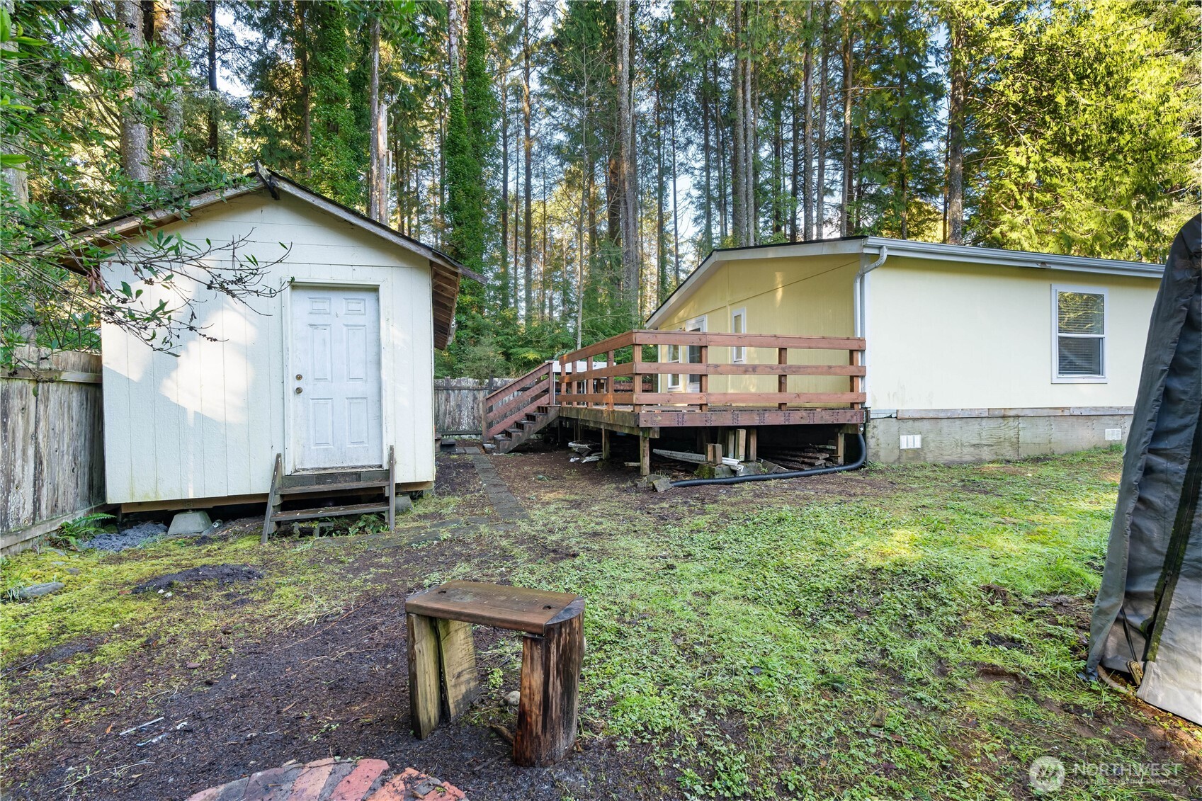48 Robin Lane Pacific Beach, WA 98571 - Photo 25 of 36 a backyard of a house with barbeque oven table and chairs