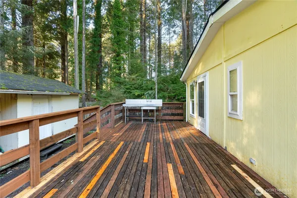 a view of deck with chairs and wooden floor