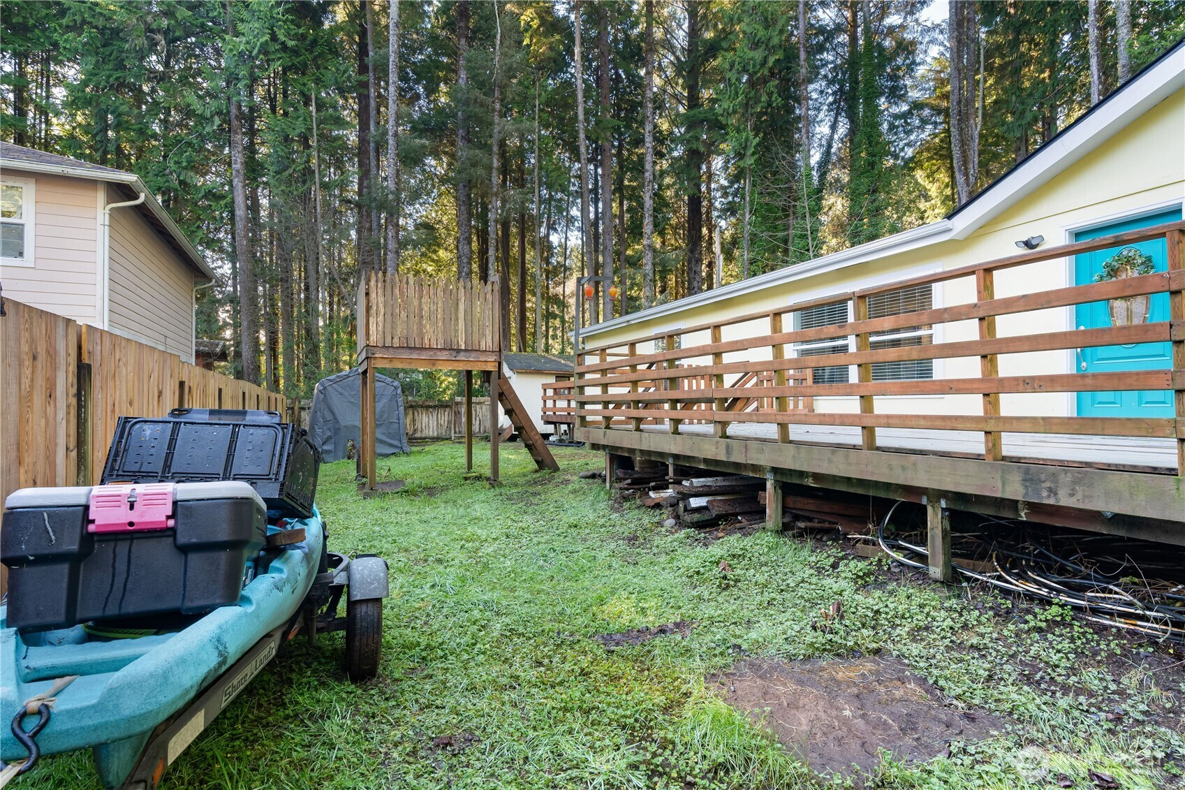 48 Robin Lane Pacific Beach, WA 98571 - Photo 28 of 36 a view of a wooden deck with chairs and a yard