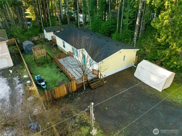 an aerial view of a house with a yard