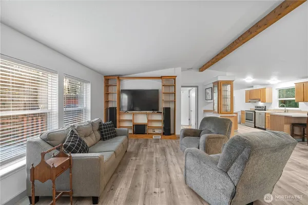 a living room with furniture large windows and a flat screen tv
