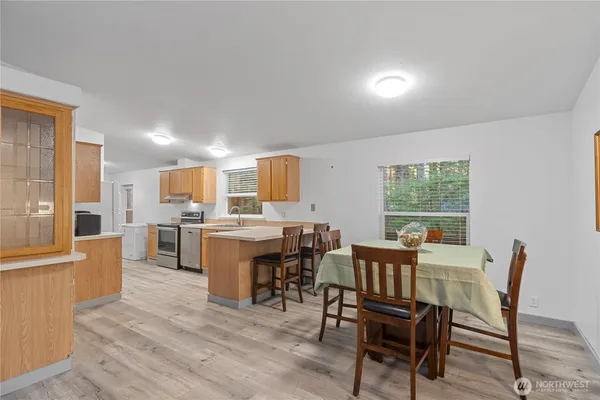 a dining room with furniture and wooden floor