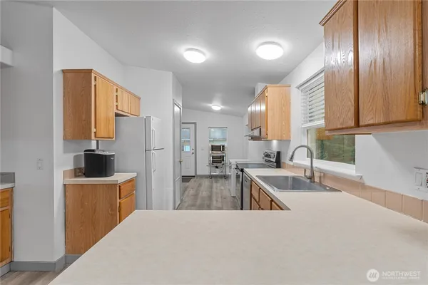 a kitchen with a sink a stove and refrigerator