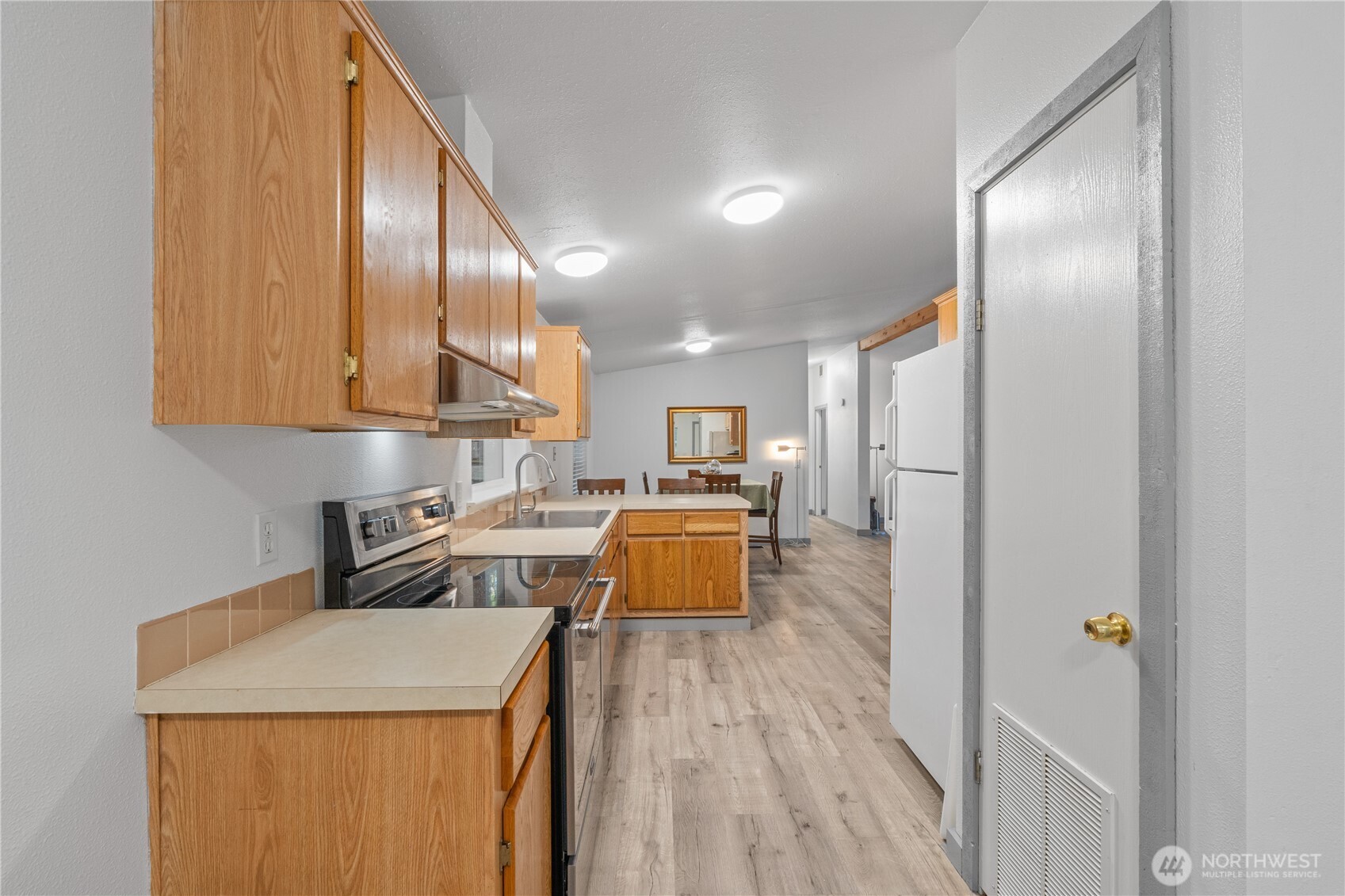 48 Robin Lane Pacific Beach, WA 98571 - Photo 8 of 36 a kitchen with a sink a counter top space stainless steel appliances and cabinets