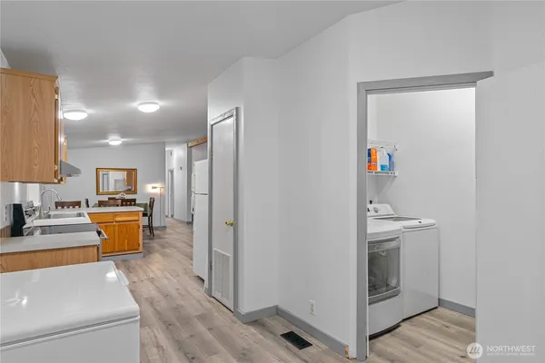 a view of living room with furniture and wooden floor