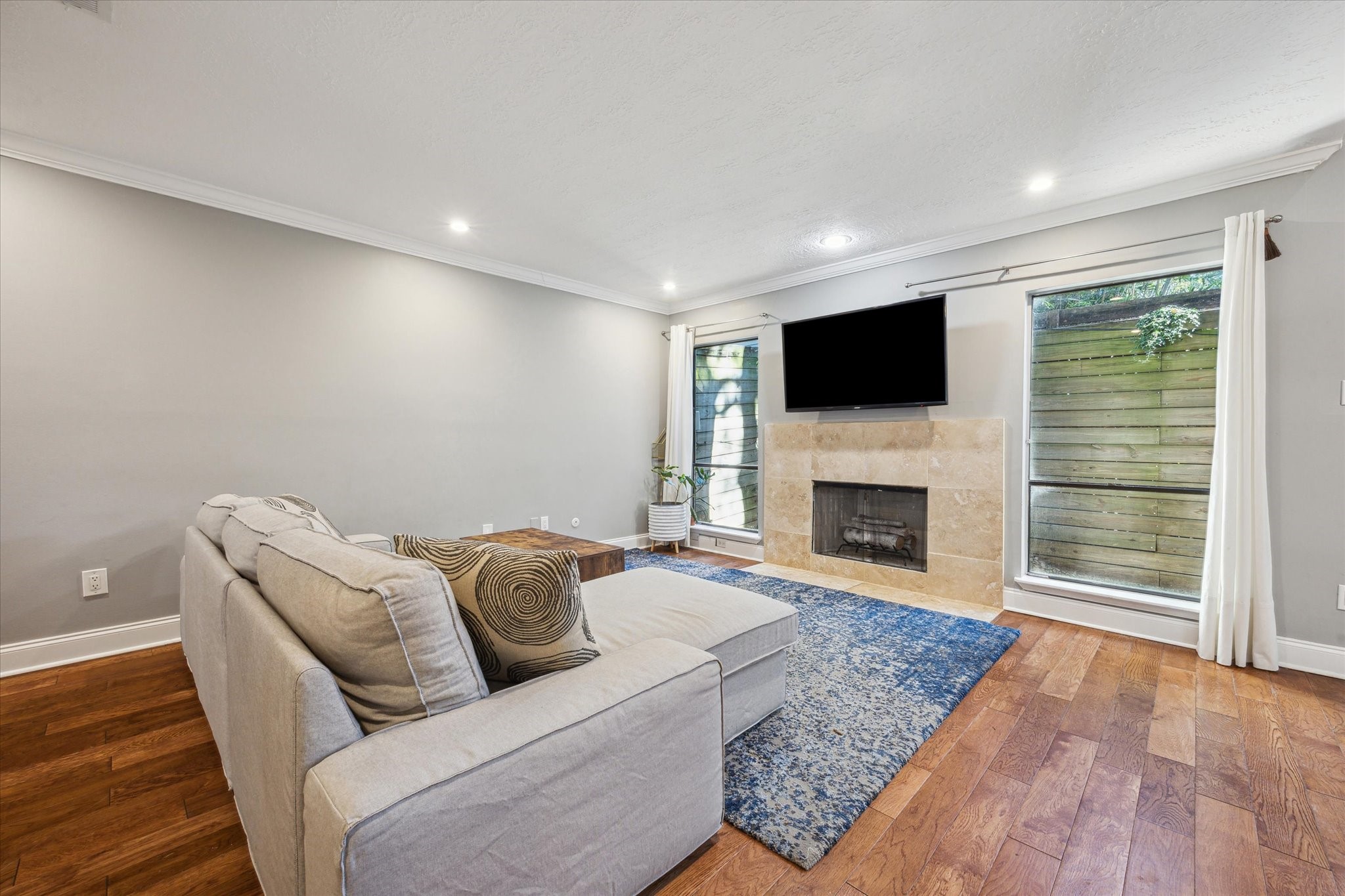 2107 Morgan Street Houston, TX 77006 - Photo 5 of 13 Natural light, hardwoods & a sleek fireplace create the perfect everyday