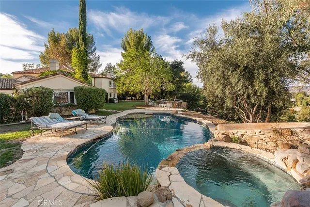 a view of a swimming pool with outdoor seating