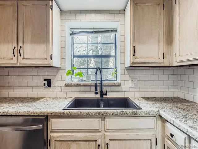 a kitchen with granite countertop a sink and a window