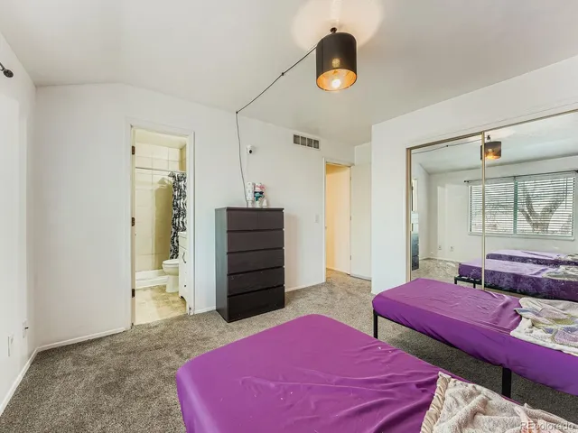 a bedroom with two beds and a chandelier