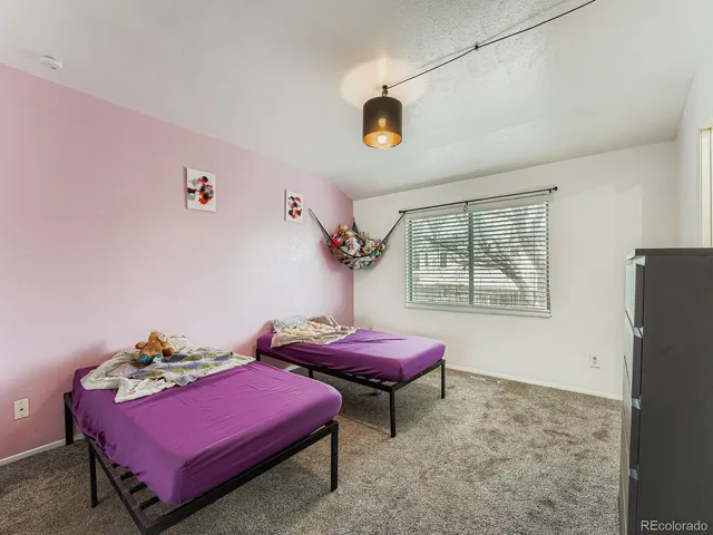 a bedroom with furniture and a window