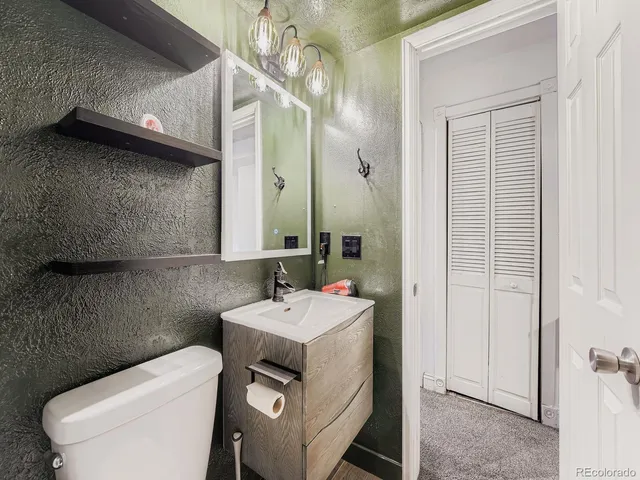 a bathroom with a sink a toilet and mirror