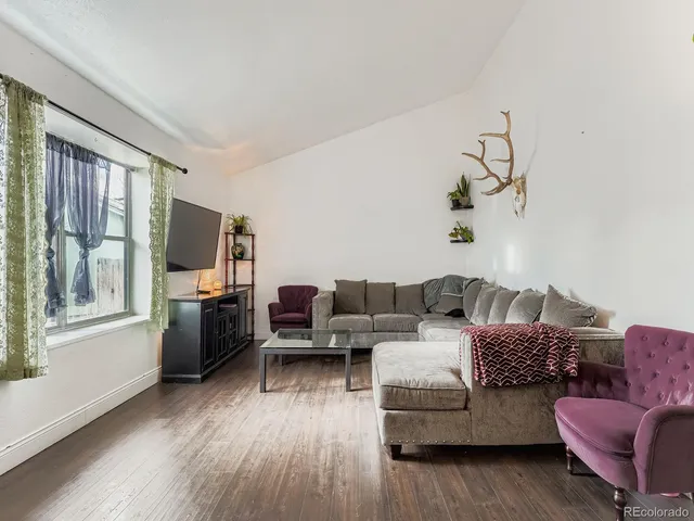 a living room with furniture fireplace and flat screen tv