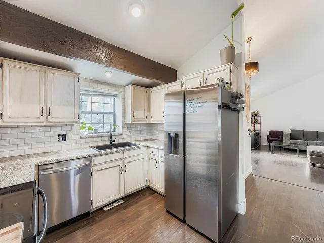 a kitchen with a sink stainless steel appliances and cabinets