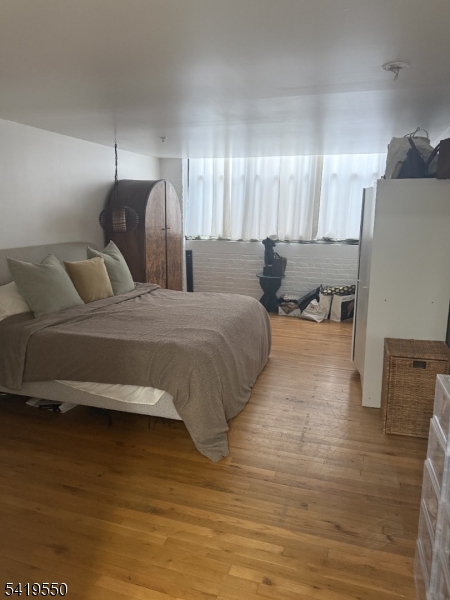 350 Scotland Road, Unit 105 Orange, NJ 07050 - Photo 8 of 17 a bedroom with a bed and a night stand