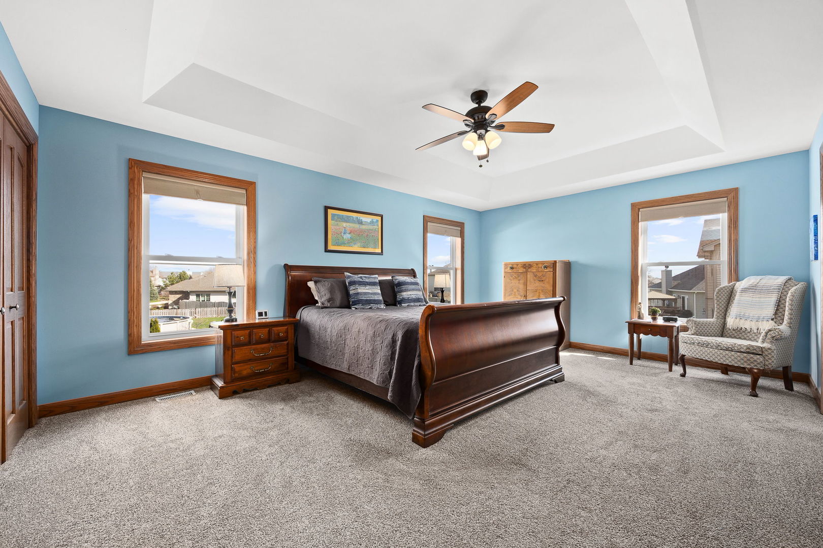 311 West Frontier Drive Minooka, IL 60447 - Photo 18 of 44 a spacious bedroom with a bed a couch and a window