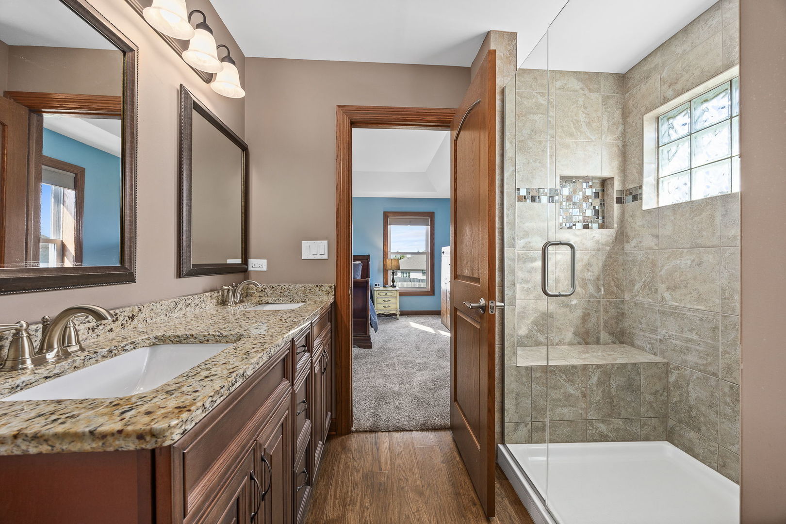 311 West Frontier Drive Minooka, IL 60447 - Photo 20 of 44 a bathroom with a granite countertop sink a mirror and shower