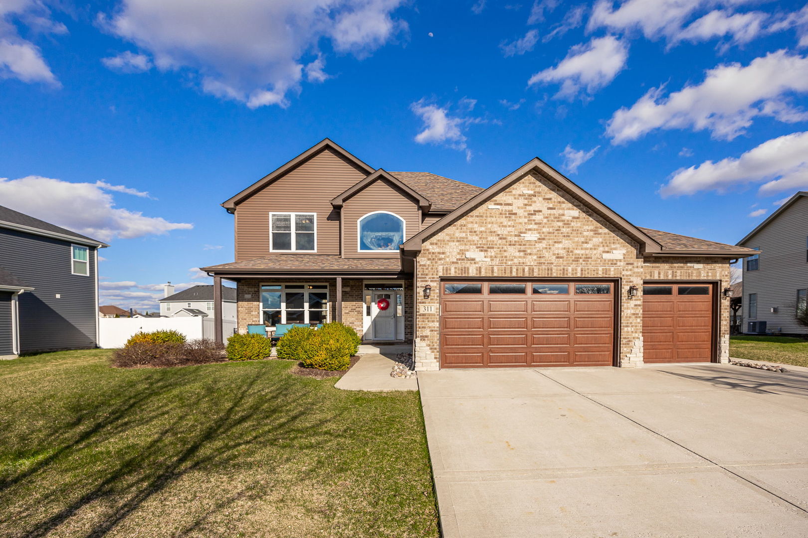 311 West Frontier Drive Minooka, IL 60447 - Photo 2 of 44 a view of a house with wooden fence