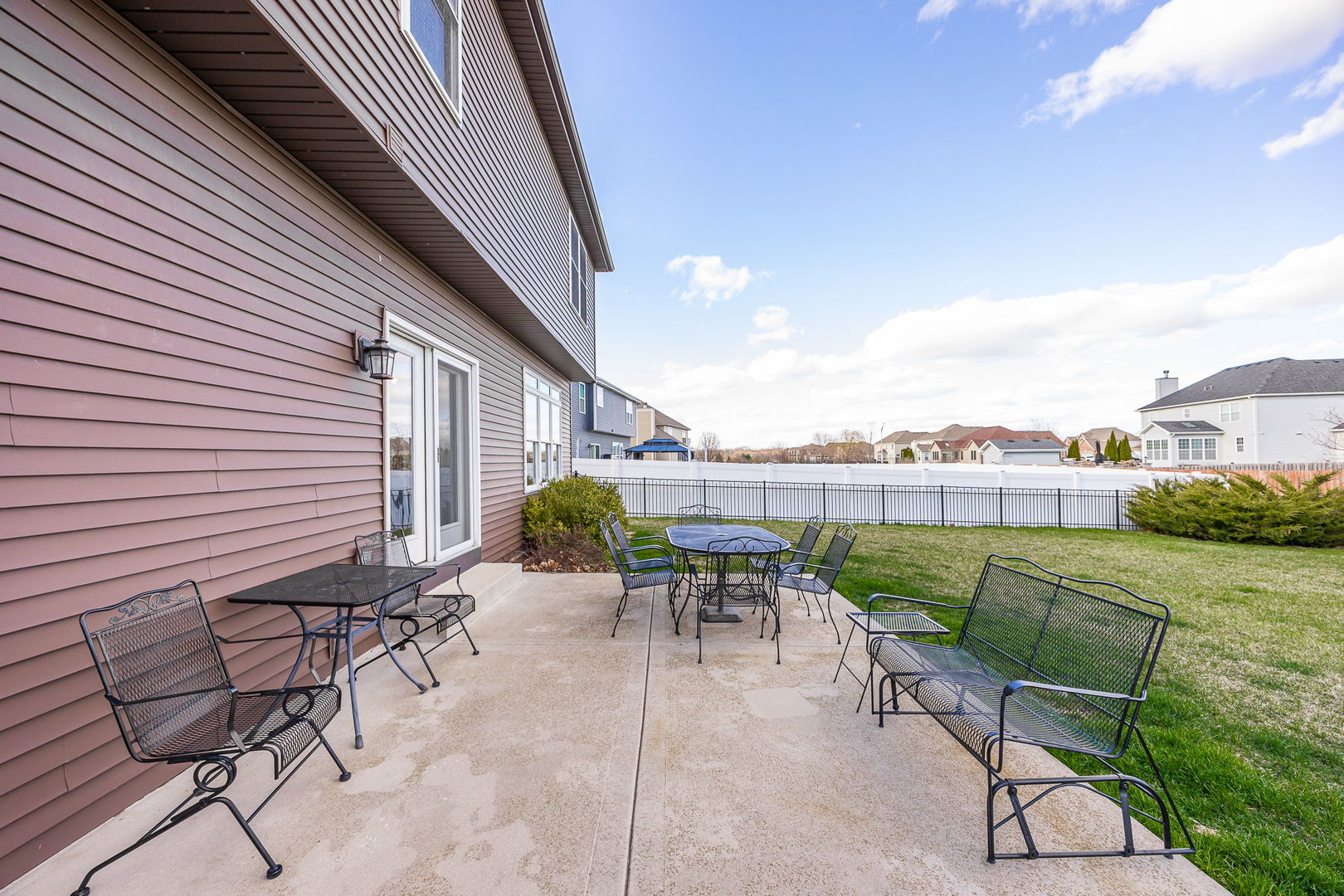 311 West Frontier Drive Minooka, IL 60447 - Photo 34 of 44 a view of a patio with a table and chairs and potted plants