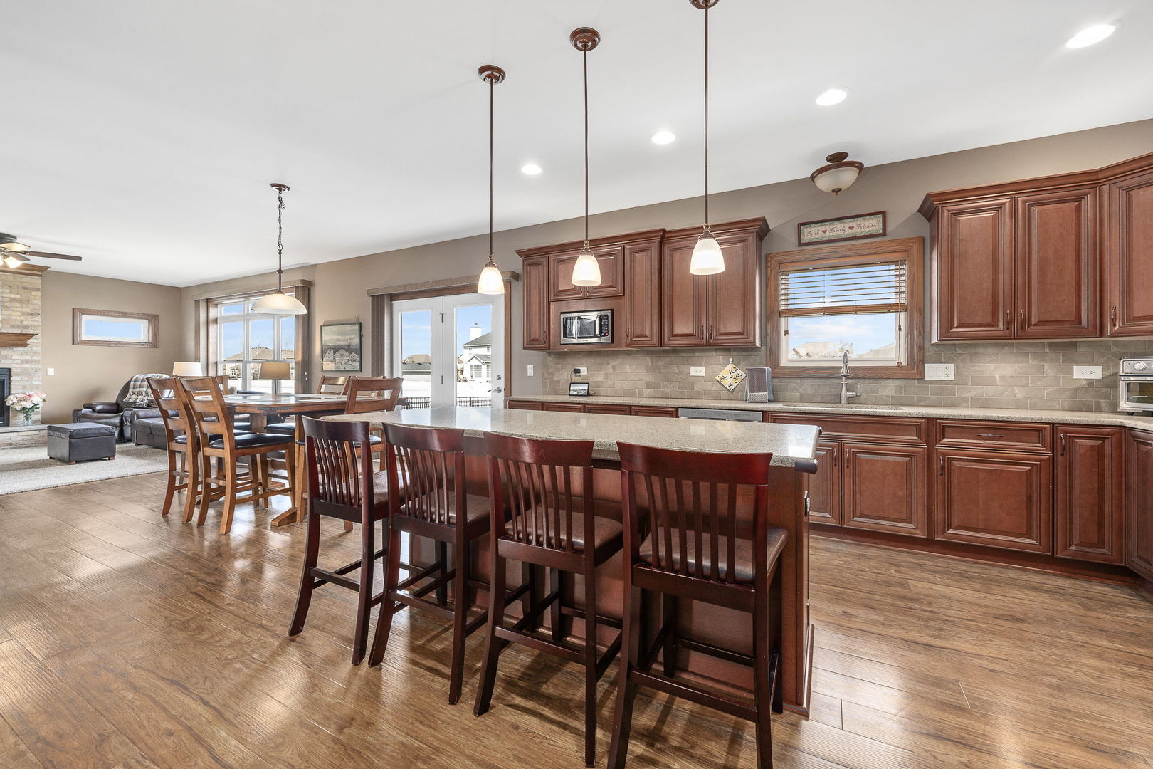 311 West Frontier Drive Minooka, IL 60447 - Photo 10 of 44 a kitchen with stainless steel appliances granite countertop wooden floors stove a sink and white cabinets