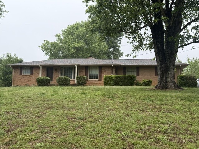 7643 Harper Road Joelton, TN 37080 - Photo 1 of 11 a front view of a house with a garden