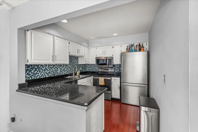 a kitchen with a refrigerator a stove a sink and a refrigerator