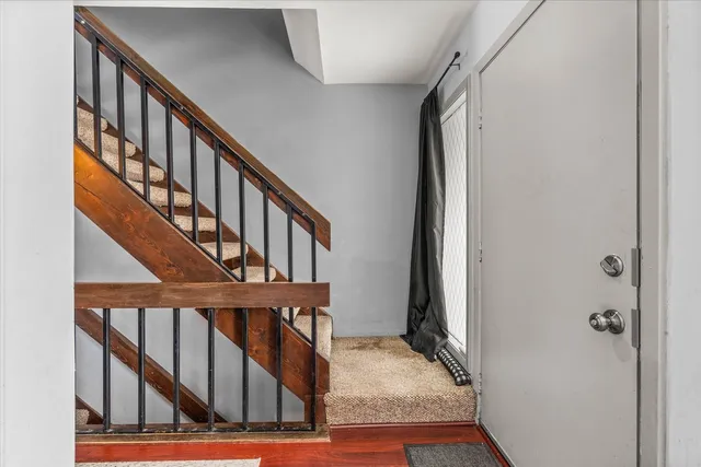 a view of staircase with wooden floor and a window