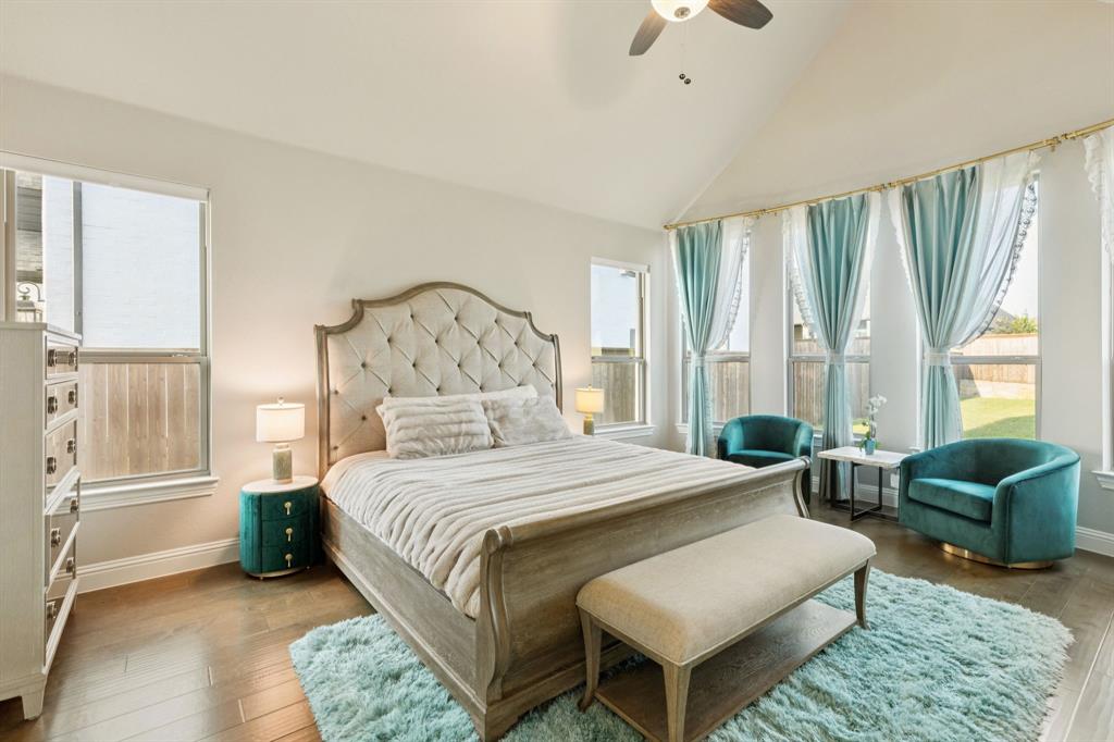 3508 Ruffian Court Celina, TX 75009 - Photo 12 of 38 a spacious bedroom with a bed a couch and a large window