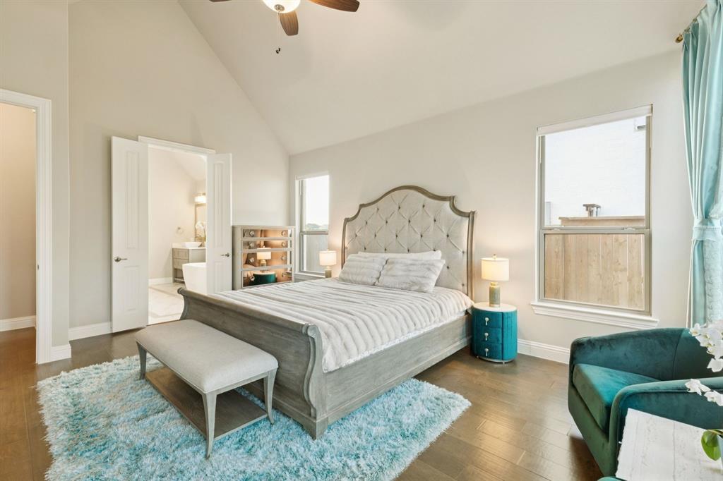 3508 Ruffian Court Celina, TX 75009 - Photo 13 of 38 a spacious bedroom with a bed a couch and windows