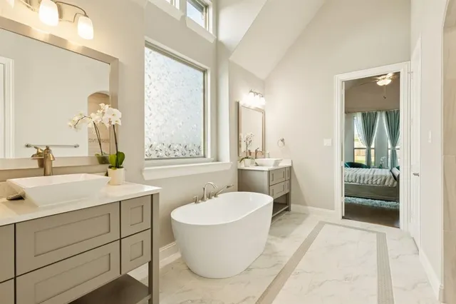a bathroom with a sink and mirror with toilet