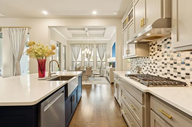 a kitchen with stainless steel appliances kitchen island granite countertop a stove a sink and a refrigerator