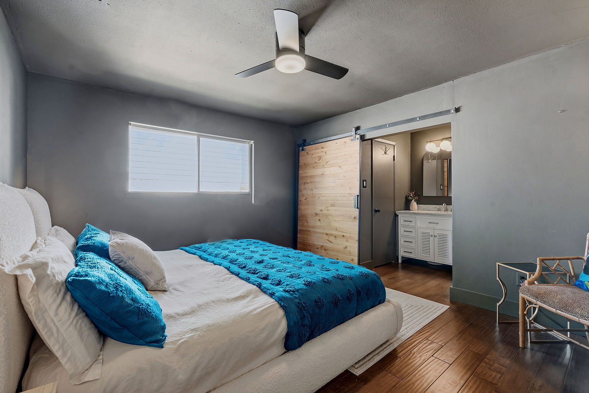 4705 Fieldstone Drive Austin, TX 78735 - Photo 15 of 34 a bedroom with a bed and a chandelier