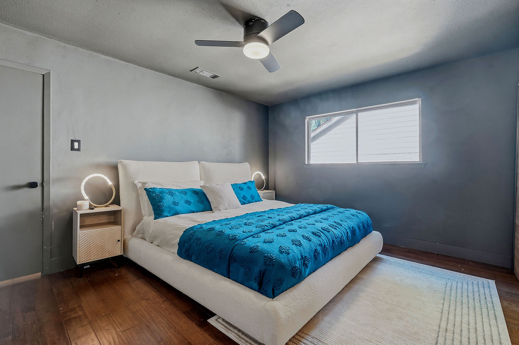 4705 Fieldstone Drive Austin, TX 78735 - Photo 16 of 34 a bedroom with a bed and a chandelier