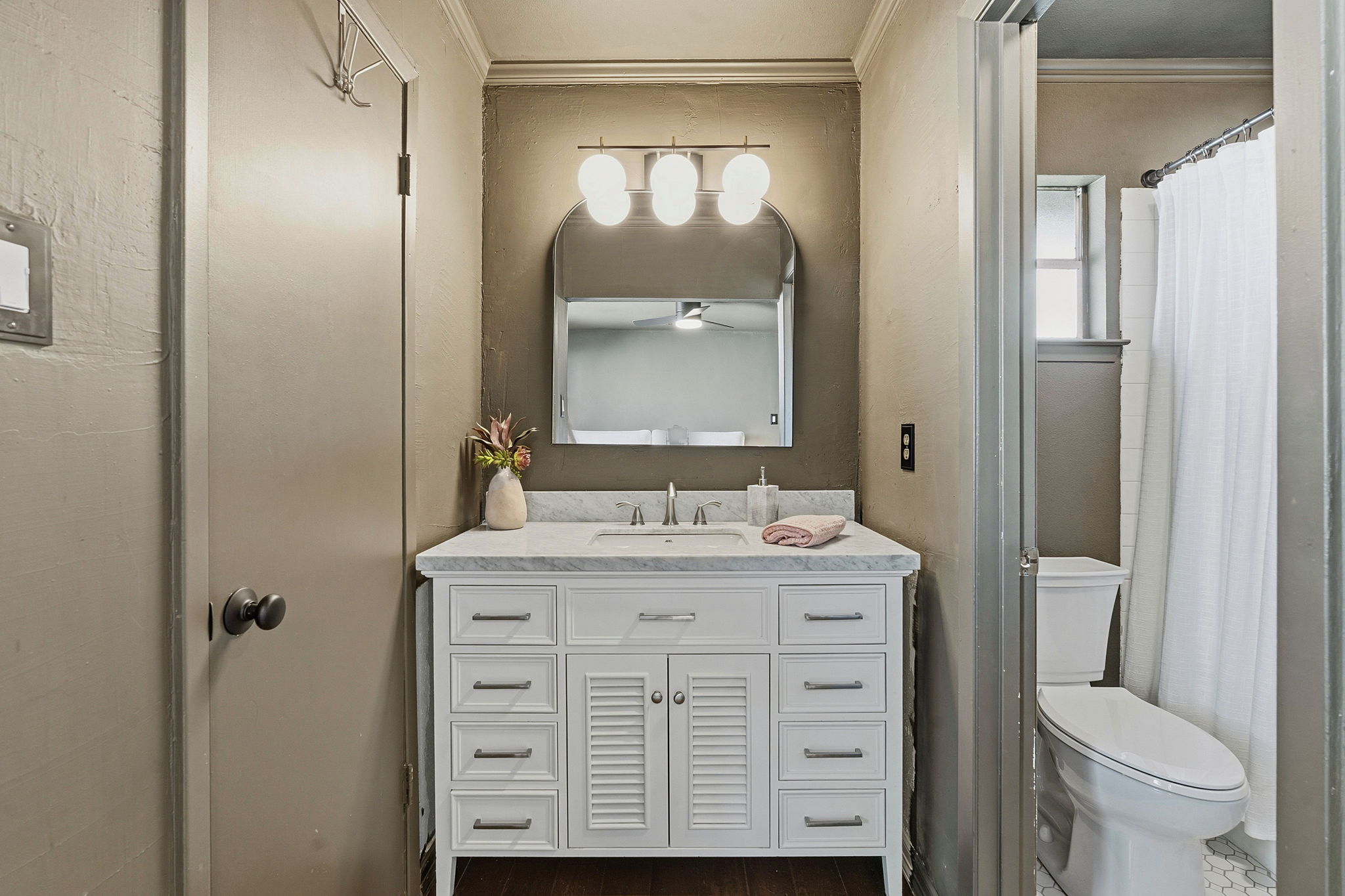 4705 Fieldstone Drive Austin, TX 78735 - Photo 18 of 34 a bathroom with a granite countertop toilet a sink a mirror and a shower