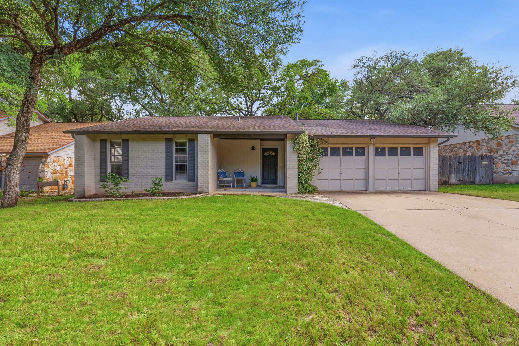 4705 Fieldstone Drive Austin, TX 78735 - Photo 2 of 34 a front view of a house with a garden and yard