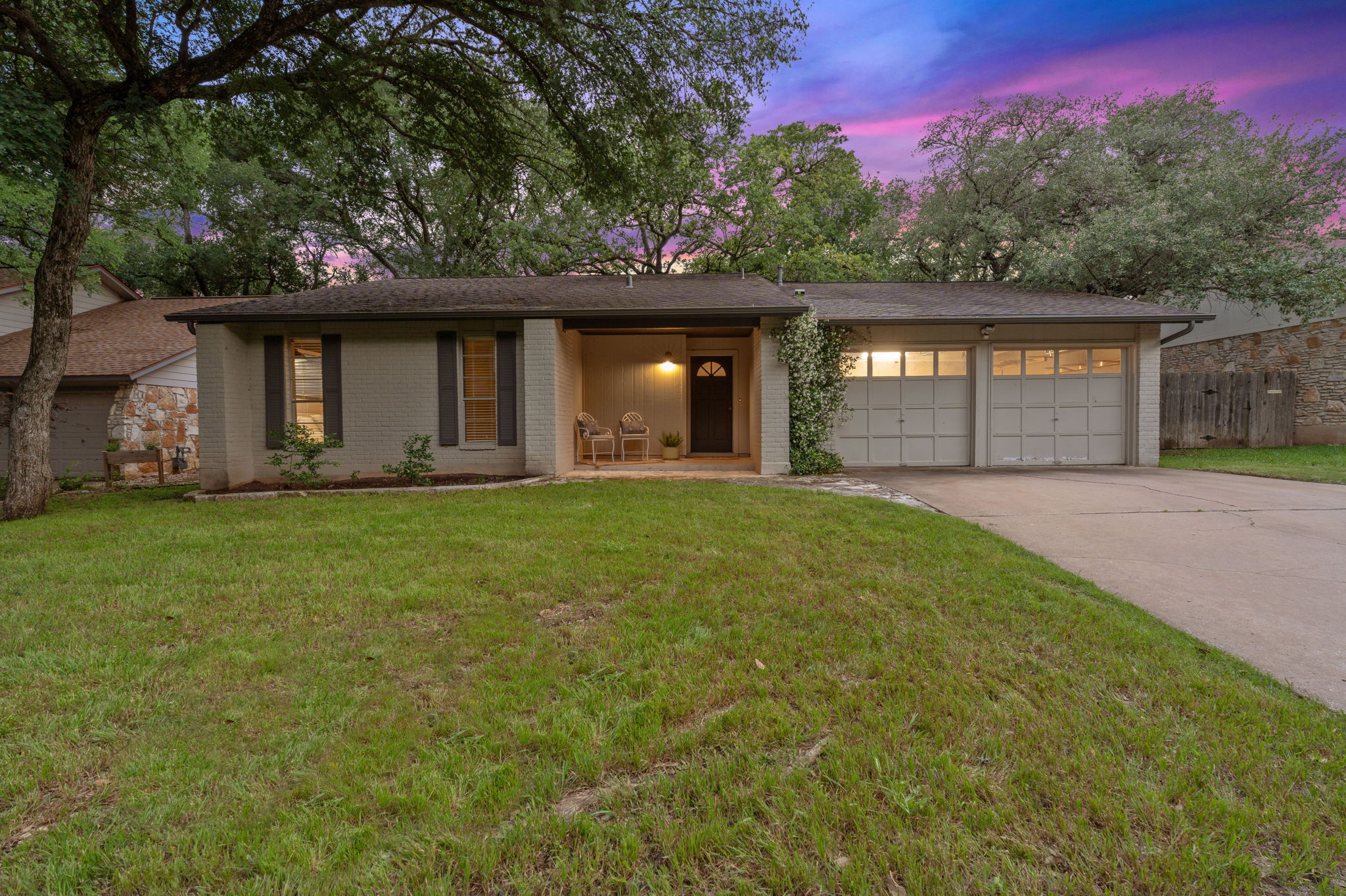 4705 Fieldstone Drive Austin, TX 78735 - Photo 25 of 34 a front view of a house with a yard and garage