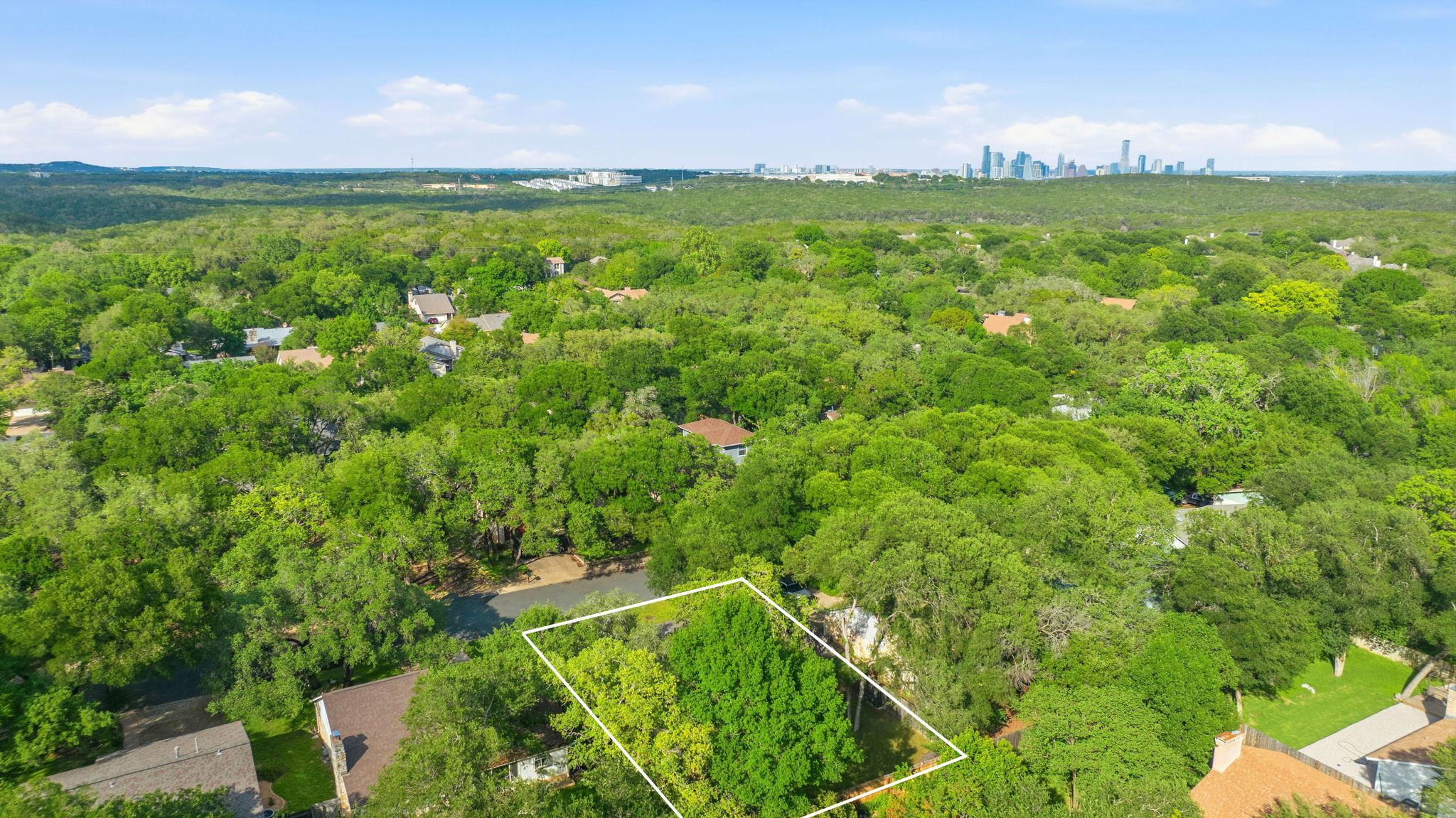 4705 Fieldstone Drive Austin, TX 78735 - Photo 32 of 34 a view of a lush green outdoor space with a swimming pool and valleys in the background